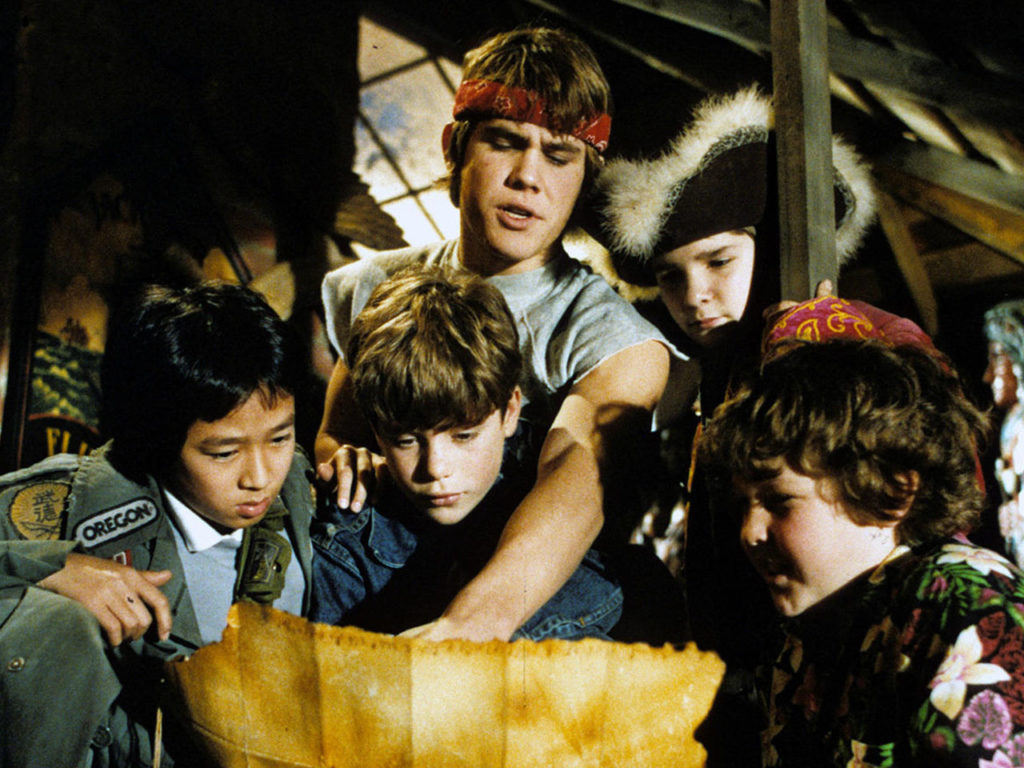 The Goonies kids gaze at One-Eyed Willy’s map in The Goonies (1985)