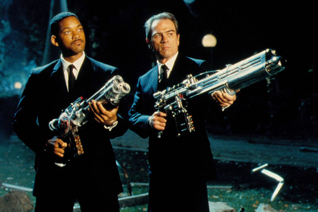 Agents J and K raise their guns in Men in Black (1997)