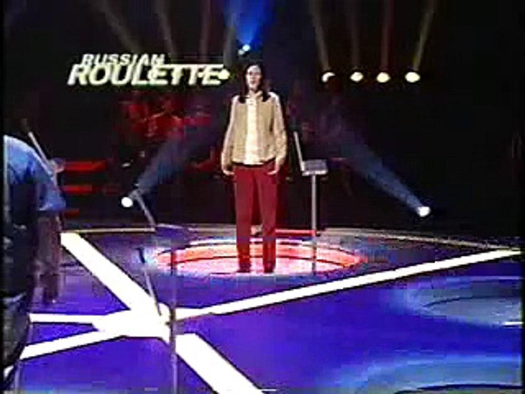 Game show contestant dropping through floor on Russian Roulette