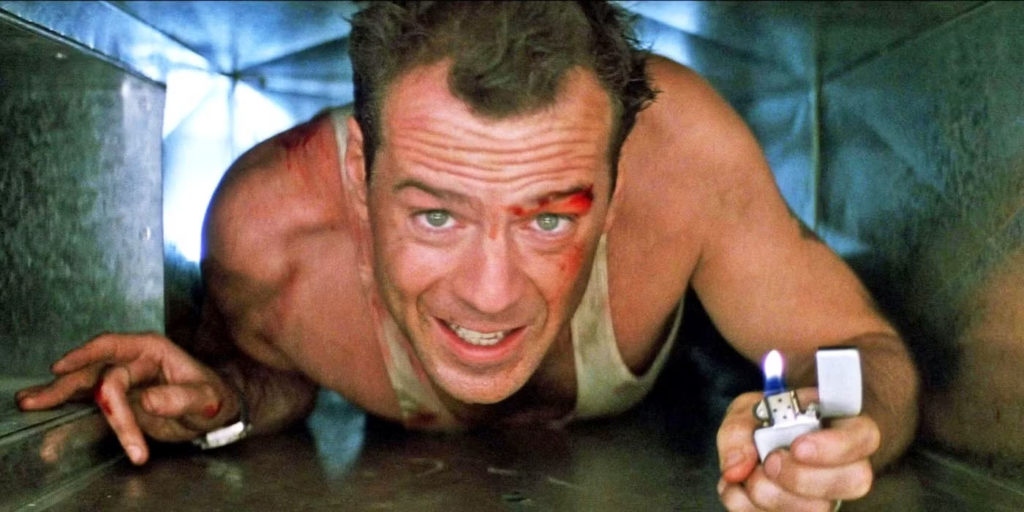 Bruce Willis as John McClane crawling through an air vent in Die Hard.