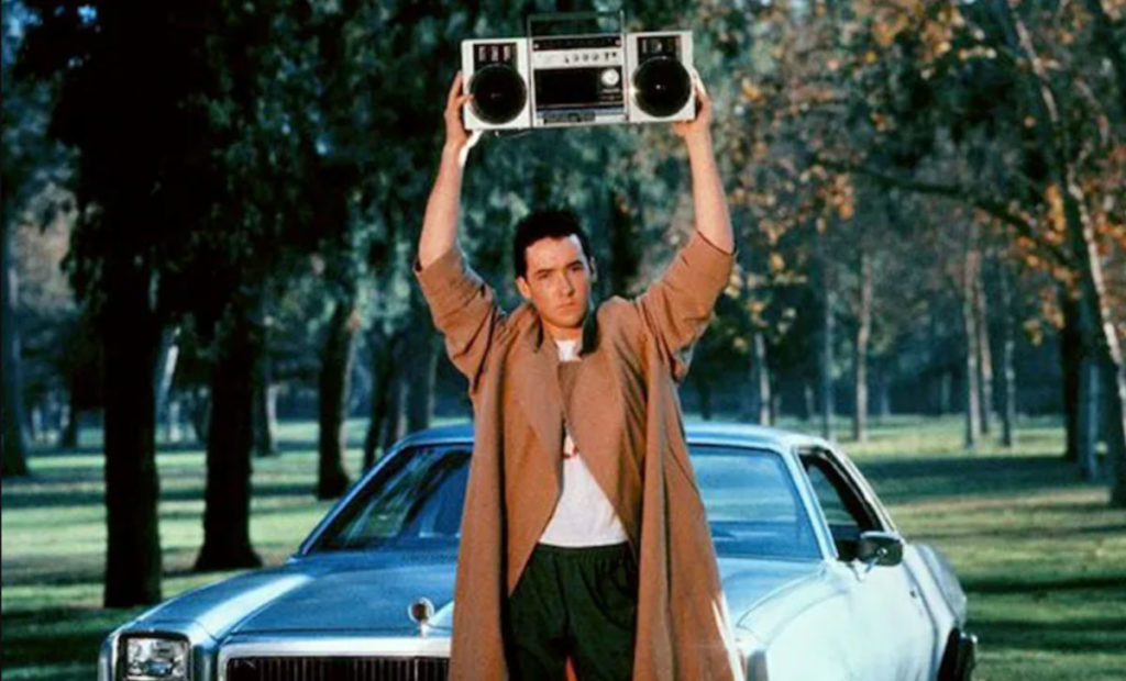 Best Romantic Comedies of 1980s - Lloyd Dobler holding a boombox outside Diane’s window in Say Anything