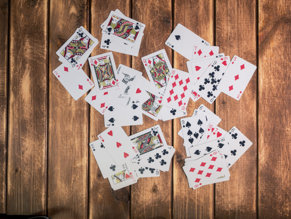 How to Play Presidents - Discard pile of face-up cards in the center of a table