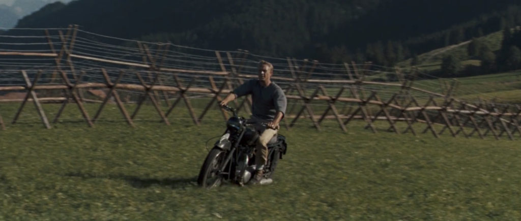 Underrated 1960s Movies - Steve McQueen riding a motorcycle near the fence in The Great Escape