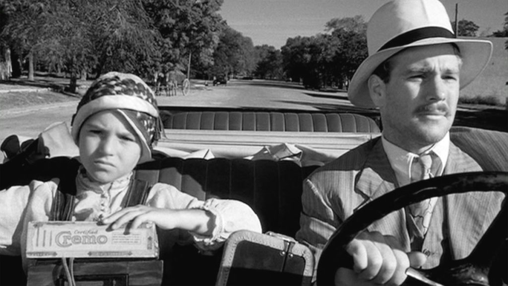 Ryan O’Neal and Tatum O’Neal riding in a car in Paper Moon