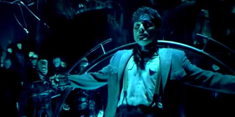 Underrated 1990s Movies - A man standing in the surreal shifting cityscape of Dark City