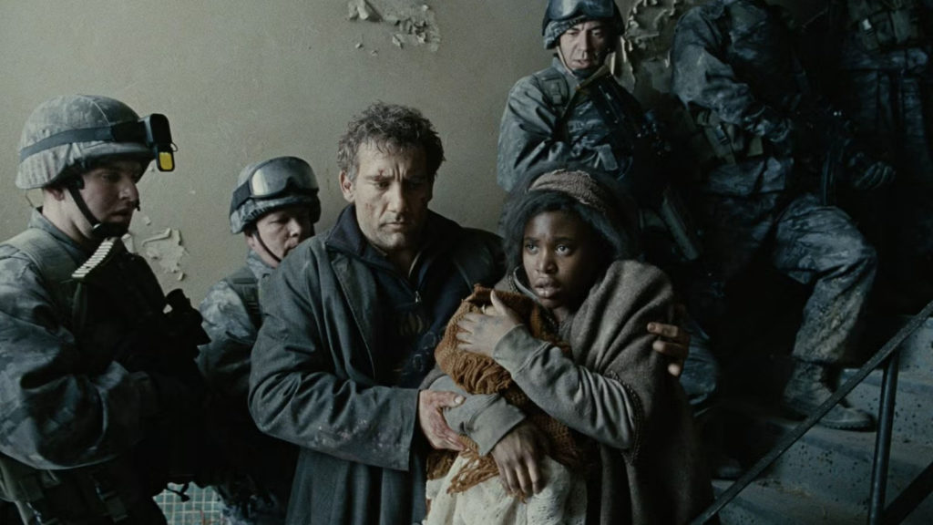 Underrated 2000s Movies - Clive Owen leading a companion down a staircase in Children of Men