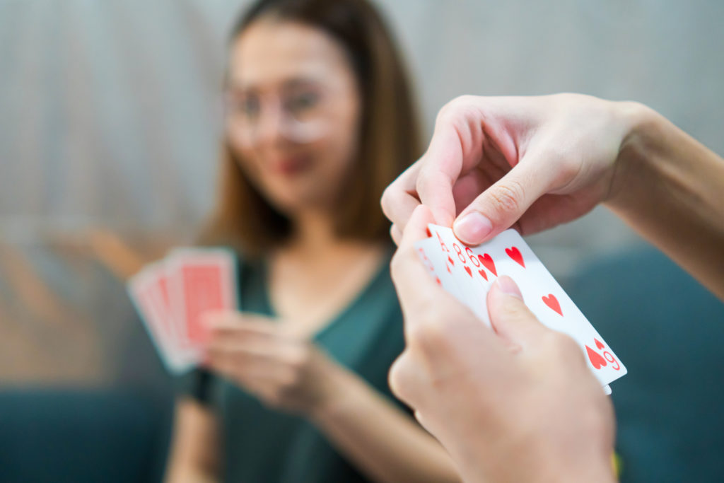 How to Play Pitch - Players arranging their cards for a hand of Pitch