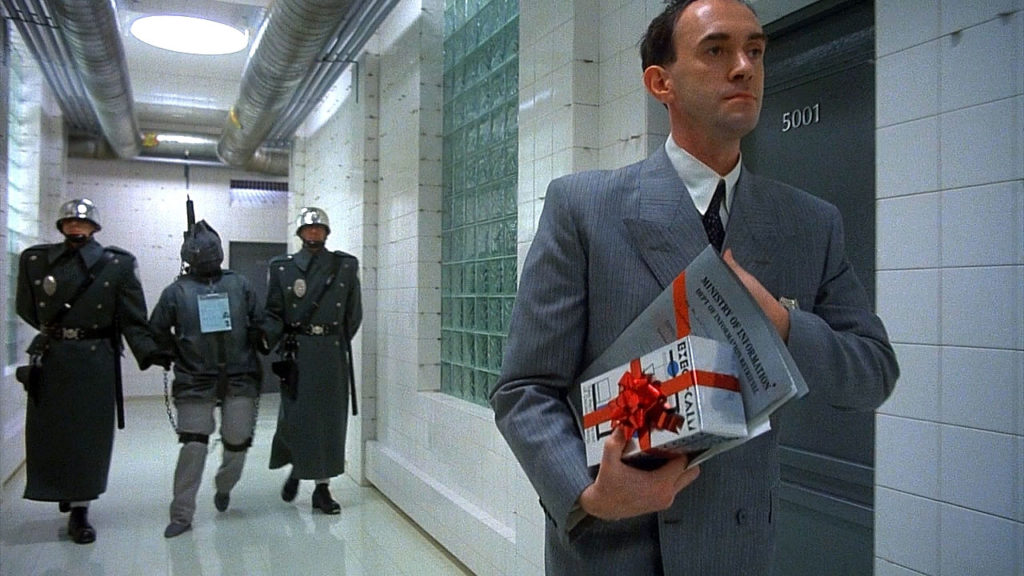 Jonathan Pryce as Sam Lowry in a surreal office scene from Brazil (1985)