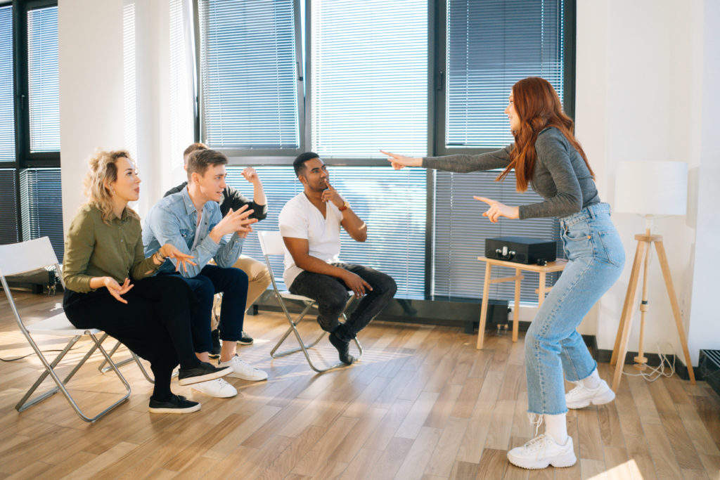 How to Play Charades - Player acting out a Charades clue for teemmates