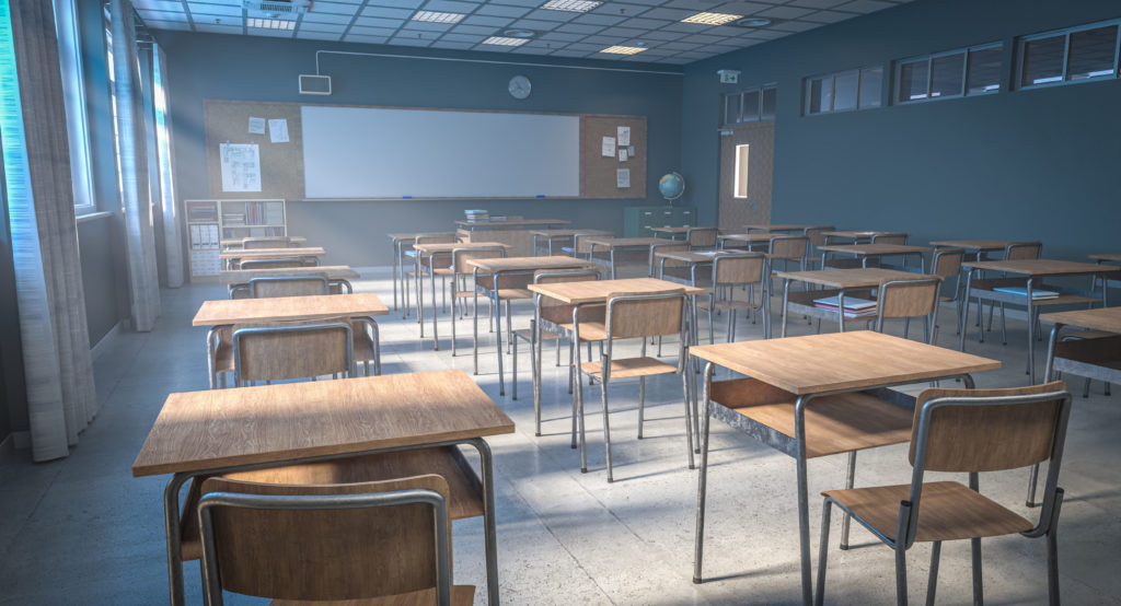Empty classroom with wooden desks and chairs awaiting students