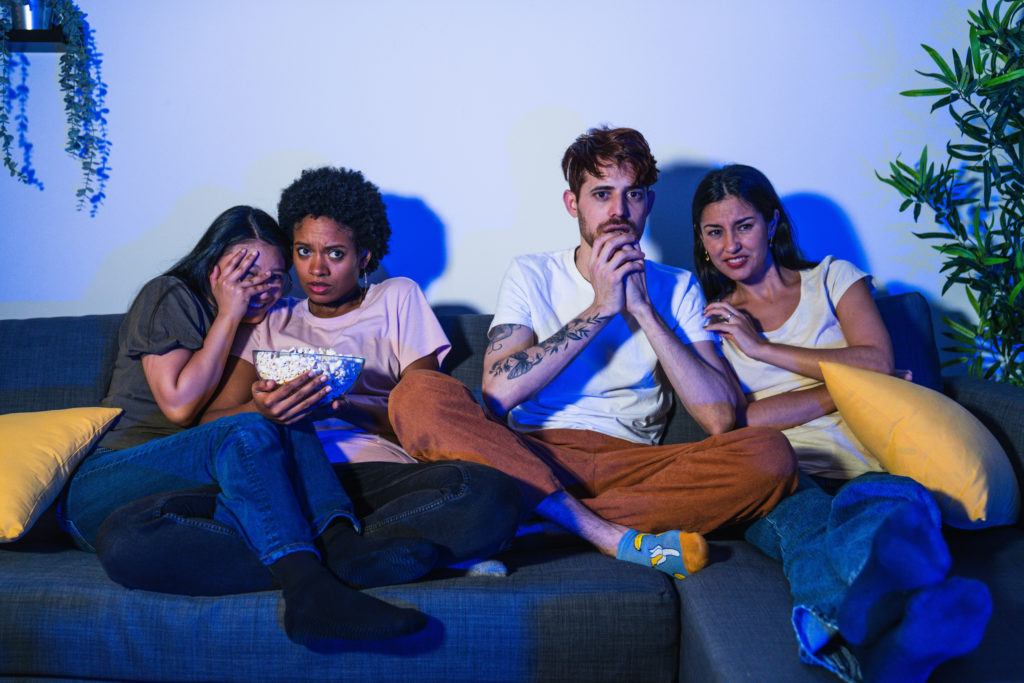 how to host a horror movie marathon - People watching a horror movie marathon