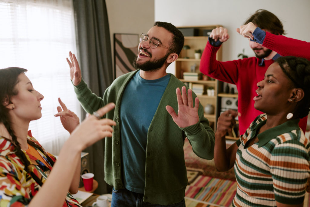 party games with no equipment - Friends playing charades